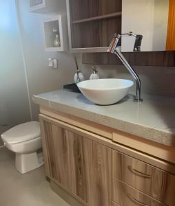 a bathroom with a white bowl sink on a counter at Casa da Tribo Hospedagem in Bom Jardim da Serra