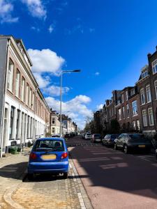 a blue car parked on the side of a street at Pondok Nyaman in Arnhem