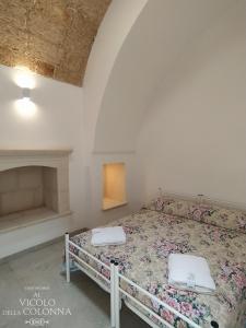 a bedroom with a bed with two pillows on it at Casa Vacanza Al Vicolo della Colonna nel centro storico di Presicce in Presicce