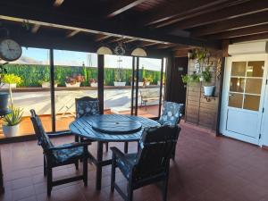a dining room with a table and chairs on a patio at casa orymar in El Cotillo