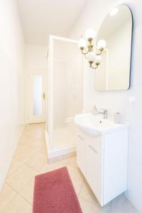 a white bathroom with a sink and a mirror at San Siro ippodromo fiera Milano apartment x4pax in Milan