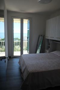 a bedroom with a bed and a balcony with the ocean at Nervi, sea view in Genova