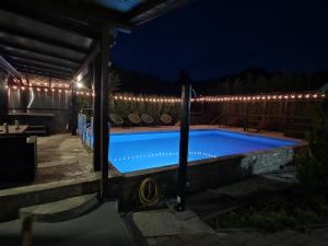a swimming pool at night with lights at Holiday House Vale Verde in Korenica