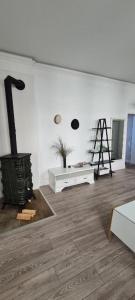 a living room with a fireplace and a wooden floor at Pasta apartment Self-Check-in in Liepāja