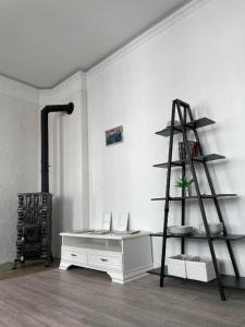 a room with a shelf and a white desk at Pasta apartment Self-Check-in in Liepāja