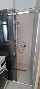 a shower with a glass door in a bathroom at Pasta apartment Self-Check-in in Liepāja +15 photos