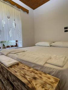 a bedroom with two beds and a window at Lengo Guest House in Gjirokastër
