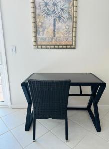 a black table and a chair in a room at Ocean Front in Cocoa Beach in Cocoa Beach +2 photos