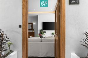 a living room with a white couch in a room at QUIYA - Luxury Condos with Exclusive Beach Club in Cruz de Huanacaxtle