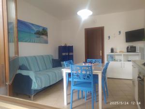 a living room with a couch and a table and chairs at Appartamento G&G in San Vito lo Capo