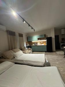 a large room with two beds and a couch at Hey Apartment 1 in Hamallë