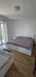 a bedroom with two beds and a window at Apartments Porat in Porat