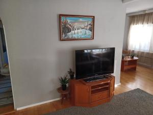 a living room with a flat screen tv on a wooden cabinet at countryside next to center in Kemi