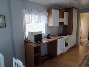 a kitchen with a desk with a computer on it at countryside next to center in Kemi