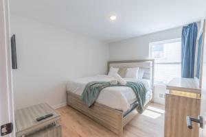 a bedroom with a bed and a television in it at muiz villa in Newark