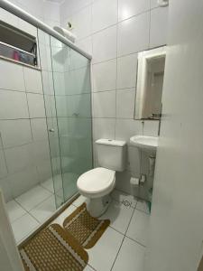 a bathroom with a shower and a toilet and a sink at Central Park in Feira de Santana