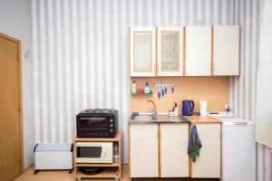 a small kitchen with a sink and a microwave at DOWNTOWN - BEST Price Small Apartment in Burgas City