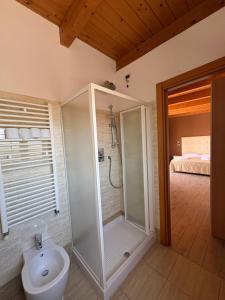 a bathroom with a shower with a toilet and a sink at Sky Rooms Attico Favorita in Cesenatico