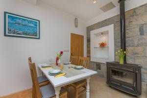 een eetkamer met een witte tafel en een open haard bij Apartment Green view in Slime