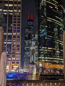a view of a city at night with tall buildings at Art Downtown Fulton Market Entire 3 bedroom Home Sleep10 Private Garage Roof EV Tesla in Chicago