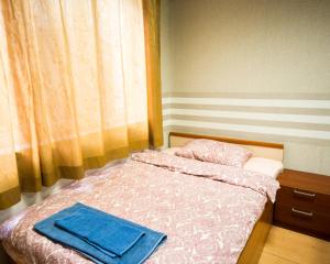 a small bedroom with a bed with a blue blanket at DOWNTOWN - BEST Price Small Apartment in Burgas City
