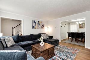 a living room with a couch and a table at 4BR Cozy Family Retreat Near Mall of GA, Near Lake Lanier - Sleeps 10 in Suwanee