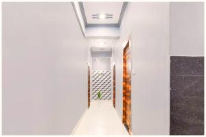 a hallway with white walls and a ceiling at HOTEL Hotel Global Inn Stay NEAR Jallianwala Bagh in Amritsar