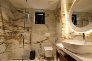 a bathroom with a sink and a shower at Rich Hotel in Pogradec