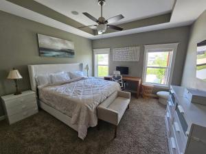 a bedroom with a bed and a ceiling fan at The Best of Marion, IA Just For YOU in Marion