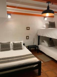 a room with two beds in a room at Finca La Manchuria in Salgar