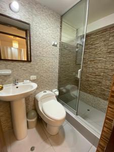 a bathroom with a toilet and a sink and a shower at Casa Yanahuara Valle Sagrado - Urubamba in Urubamba