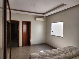 an empty room with a bed and a window at Casa Bahia Farm Show in Luis Eduardo Magalhaes
