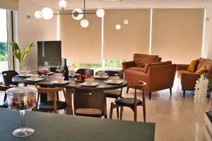 a dining room with a table and chairs and a couch at Villa Campagna in Trogir