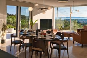 a dining room with a table and chairs in a living room at Villa Campagna in Trogir