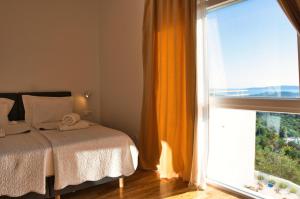 a bedroom with a bed and a large window at Villa Campagna in Trogir +35 photos