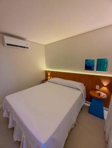 Cama ou camas em um quarto em Porto Suítes Natal Hotel