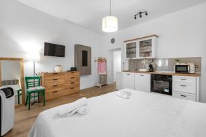 a kitchen with a large white bed in a room at Medulic in Šibenik +12 photos