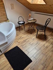 a bathroom with a toilet and a table and chair at New York Vintage Industrial Style in Košice