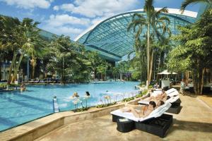 a group of people sitting in chairs in a pool at a resort at Heimatstub' Hinterzarten in Hinterzarten