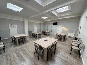 a large room with tables and chairs and skylights at Aparthotel Emilia in Bargteheide