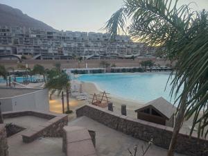 a large swimming pool in front of a large building at Luxury Chalet Il Monte Galala in Ain Sokhna
