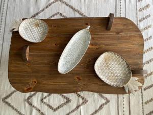 a wooden cutting board with three leaves on it at Luxury Chalet Il Monte Galala in Ain Sokhna