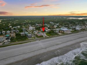 a red arrow on a road in front of houses at Salty Greek in Flagler Beach