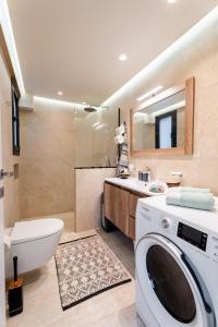 a bathroom with a washing machine and a sink at NiMar luxury city villa with jacuzzi in Rhodes Town +55 photos