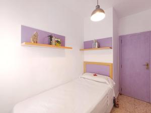 a bedroom with a bed and a purple door at La Font Moraira in Moraira +12 photos
