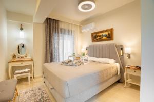 a bedroom with a large bed and a window at NiMar luxury city villa with jacuzzi in Rhodes Town