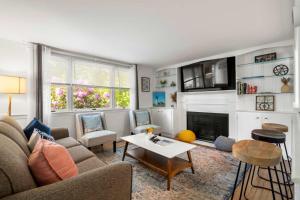 a living room with a couch and a fireplace at Deeded Pond Access Ping Pong in Harwich