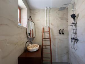 a bathroom with a ladder and a sink and a shower at Akil Villa in Dhërmi +30 photos