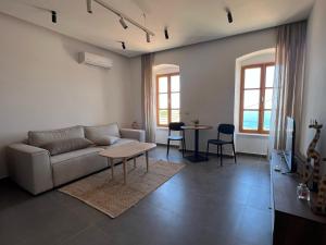a living room with a couch and a table at Akil Villa in Dhërmi
