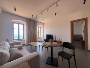a living room with a couch and a table at Akil Villa in Dhërmi